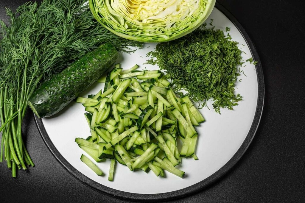 A plate of cucumbert, cabbage and thyme.