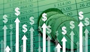 A photo of coins on a paper with some reports and arrows pointing upwards with $ sign each.