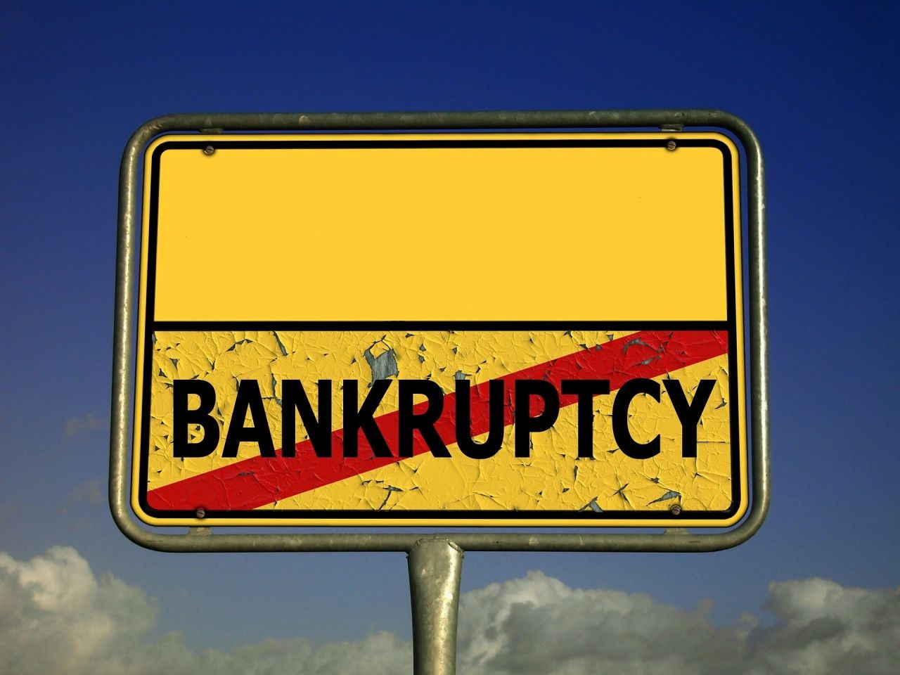 A yellow signage with black text that says: "Bankruptcy"