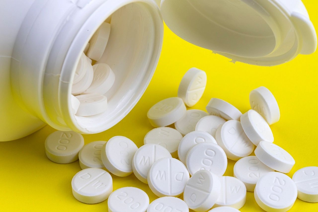 A prescribed medicine tossed on a yellow table.